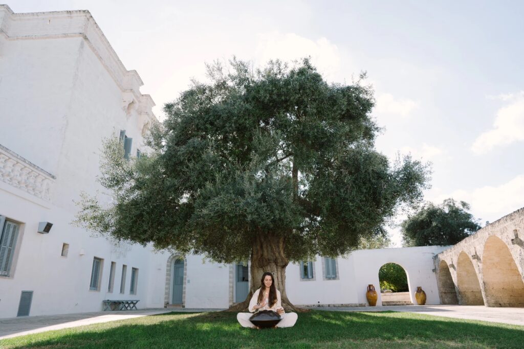 woman meditating under a tree