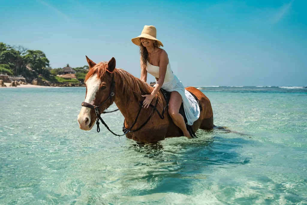 woman horse riding in the sea