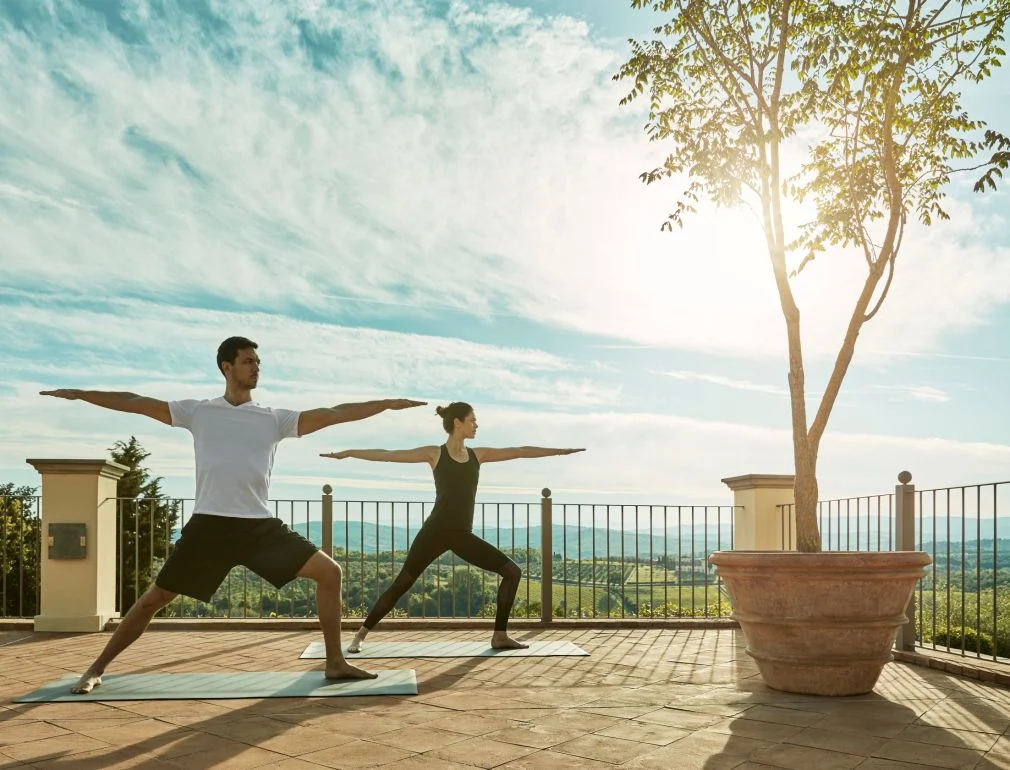 couple doing yoga outside